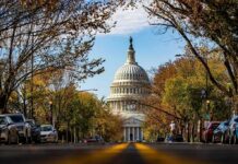 House Moves Against Backdoor Riches United States Capitol dome framed by a tree-lined street