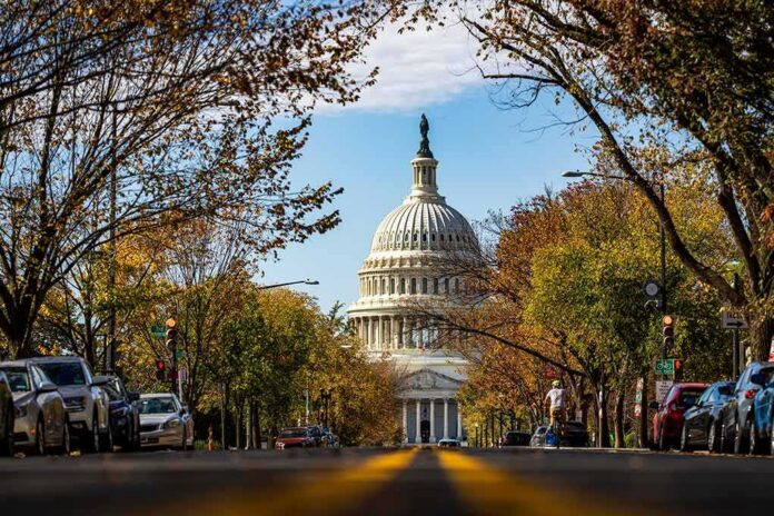 shutterstock_2572235099 United States Capitol dome framed by a tree-lined street