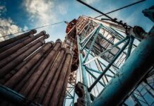 Trump’s Big Bet: Alaska Pipeline Payday Oil drilling rig structure with stacked pipes viewed from below