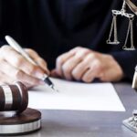 Power Play: Freeze The Supreme Court Judge writing at desk with gavel and Lady Justice statue