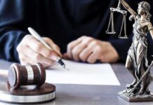 Power Play: Freeze The Supreme Court Judge writing at desk with gavel and Lady Justice statue