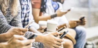 Group of people sitting and using smartphones