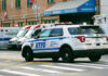 Bridge Commute Turns Deadly – Shooter Vanishes Police car and ambulances outside emergency room entrance.