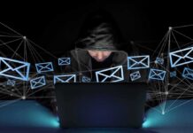 Masked Calls Terrorize Ex-White House Aide Hooded person using a laptop surrounded by email icons