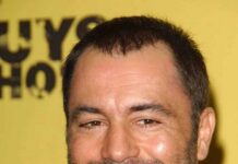 Smiling man with short hair and stubble