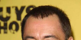 Smiling man with short hair and stubble
