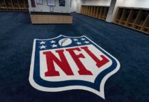 NFL Star Rocked By Explosive Trial NFL logo on the floor of an empty locker room
