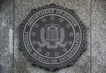 Livestream Scheme Tied To Deadly Rampage FBI seal mounted on a granite wall