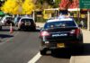 Midnight Gunfire Shatters Vienna Homecoming Police cars with flashing lights near school buses on a city street