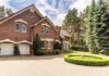 Red brick house with circular driveway and fountain