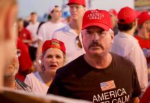 Darren Balsley in a red cap at a crowded outdoor event