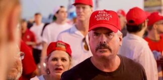 Darren Balsley in a red cap at a crowded outdoor event