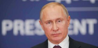 Vladimir Putin at a podium with microphone