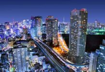 Marine Murder Fury Ignites Okinawa City skyline at night with illuminated skyscrapers and highways
