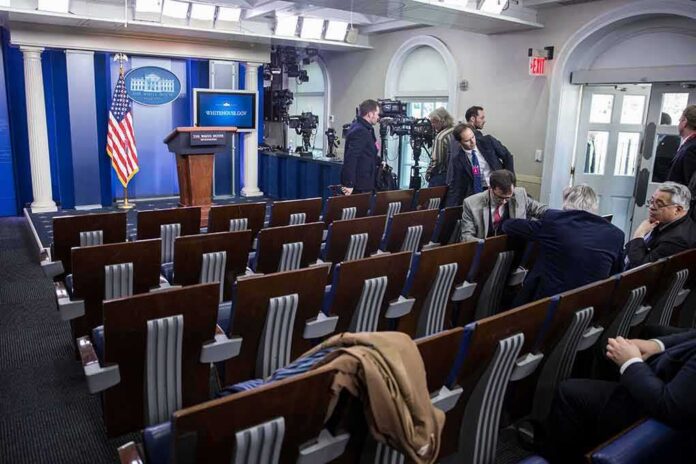 shutterstock_1465699346 White House press briefing room with empty seats and cameras