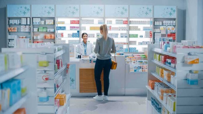 shutterstock_1952231947 Yvonne Li assisting a customer at a pharmacy counter