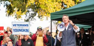 Man with megaphone addressing crowd at outdoor rally