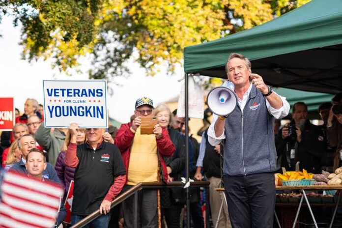 Man with megaphone addressing crowd at outdoor rally