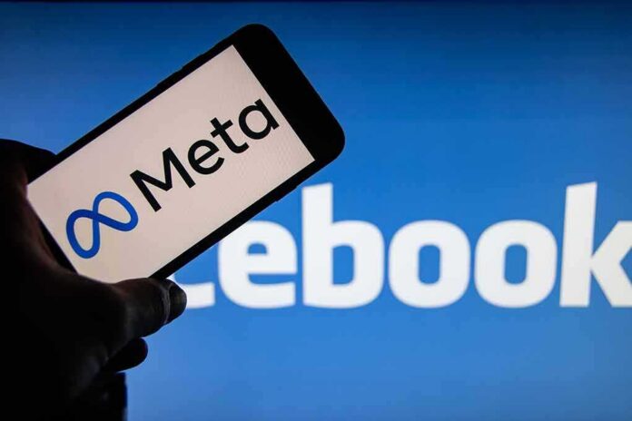 shutterstock_2066596991 Smartphone showing Meta logo against blurred Facebook background