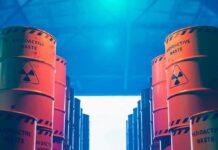 Radioactive waste barrels stacked in rows inside a facility