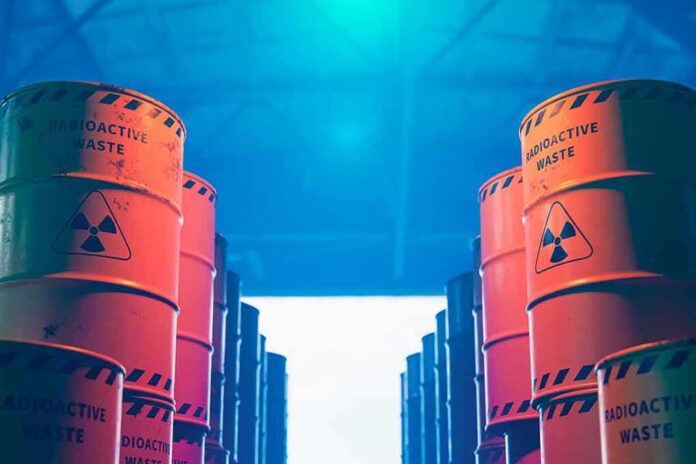 Radioactive waste barrels stacked in rows inside a facility