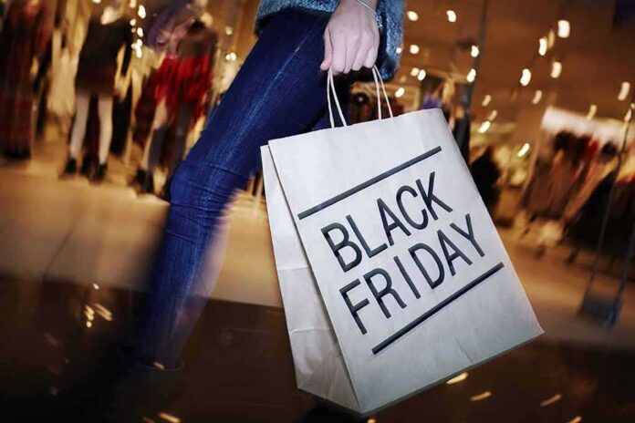 shutterstock_337424894 shopper holding a large paper bag in a mall