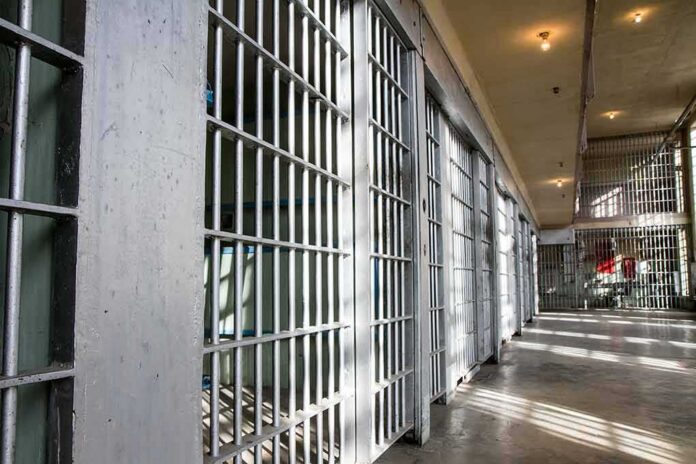 shutterstock_376750576 Prison cell block with metal bars and corridor