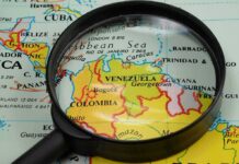 Election Shock Rocks Caracas Magnifying glass over a map of northern South America