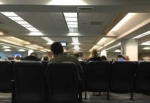 NJ Mayor SNAPS, Charges Seated Critic People seated in a waiting room with rows of chairs