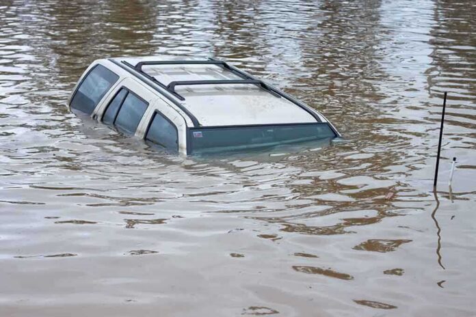 shutterstock_68552284 A partially submerged vehicle in floodwaters