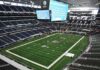 American football stadium interior with large central video board