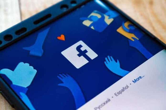 shutterstock_772838107 Smartphone screen showing Facebook app logo and icons